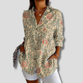 Blusa elegante a maniche lunghe con fiocco floreale per un look raffinato