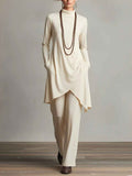 Set elegante top con collo alto e pantaloni con orlo asimmetrico
