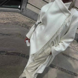 Oversized wool coat with turtleneck, knot, and asymmetrical buttons